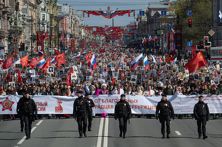 People carry portraits of their relatives who participated in World War II during the "Immortal Regiment" march on Victory Day along Nevsky Prospect. Victory Day parade at Palace Square to commemorate the 80th anniversary of the Soviet Union's victory over Nazi Germany in World War II. The parade featured over 5,500 military personnel, including St. Petersburg garrison troops, emergency services, cadets, and a unique unit of Cossacks honoring their historical role in defending Leningrad. More than 90 units of military equipment were displayed, and veterans were invited, with around 400 receiving invitations. Access to Palace Square was by invitation only, but spectators could watch from areas like the Alexander Garden and Palace Embankment. The event coincided with a massive Immortal Regiment march along Nevsky Prospekt, with approximately one million participants carrying portraits of WWII relatives.