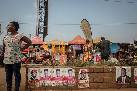 A woman stands next to Samantha Nassolo and Bakaluba Mukasa election posters in Kampala.
Uganda's elections are expected to take place early next year.