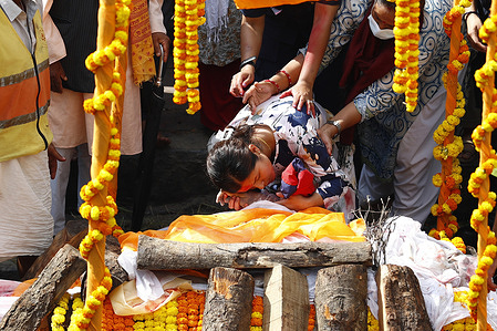 The wife of Assistant Sub-Inspector Milan Raya who was brutally killed during the Gen Z protests holds the hand before his cremation at Pashupatinath Temple. The Police performed a guard of honor. It marks the fifth day of an army-imposed curfew during which more than 51 people have been killed. The Gen Z protests fueled by anger over corruption and the social media ban forced Prime Minister K.P. Sharma Oli to resign.