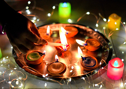 Earth lamps being decorated with oil and Chinese lights during the Diwali festival.
Deepavali or Dipavali is a four-five day-long festival of lights, which is celebrated by Hindus in every autumn all over the world.
