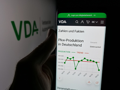 In this photo illustration, a smartphone with the web page of German Verband der Automobilindustrie (VDA) is seen on screen in front of logo.