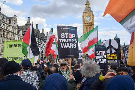 Demonstrators hold 'Stop Trump's Wars' placards during a protest against the war with Iran in Parliament Square, as USA and Israel launch attacks on Iran.