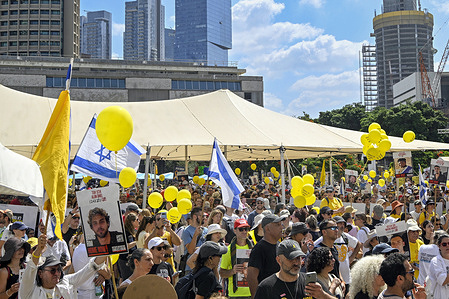 Protesters hold yellow balloons a symbol of the struggle to free the hostages during the demonstration. A day of strike and demonstrations calling for the immediate release of all hostages and an end to the war.