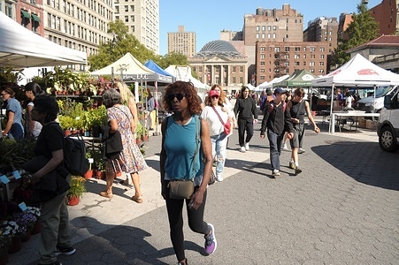 People walk past markets in Union Square, Manhattan, New York City.