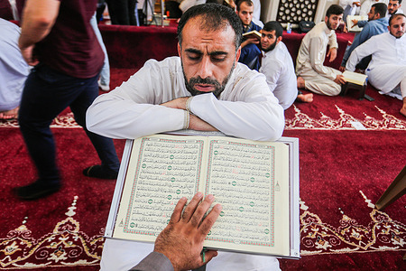 A Palestinian Muslim man reads the Noble Quran during one sitting at the initiative of the House of the Quran and Sunnah in Gaza City. Palestinians read the holy Quran during one session. It was an initiative of Dar Al quran and Sunnah, in Gaza city on August 23, 2022. More than 500 memorizers read the Holy Quran in one session, at the initiative of Dar Al quran and Sunnah for the first time in the Gaza Strip.