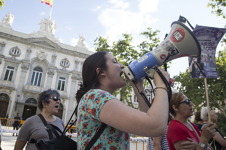 A protester shouts slogans on a megaphone during the demonstration.
The feminist collective of Madrid demonstrate in front of the Supreme Court of Spain after the decision of the Court to change the verdict of sexual abuse to rape to the members of the case that happened in Pamplona, Navarre, Spain on 7 July 2016 during San Fermín celebrations. The Spanish Supreme Court raised the prison sentence to 15 years on the grounds that sexual aggression did exist.