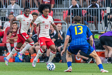 Illya Zabarnyi #13 (R) and Jayden Nelson #25 (L) seen in action during the Canadian Shield Tournament match between Ukraine and Canada at BMO Field. Final scores; Canada 4-2 Ukraine.