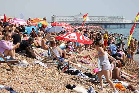 Thousands of sunbathers enjoy the hot, sunny weather on Brighton Beach in East Sussex. An amber heat-health alert is active nationwide, with temperatures expected to reach 34°C, during the UK’s fourth heatwave of the year.