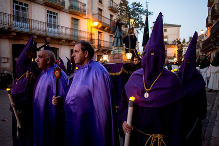 Members of the Veracruz brotherhood carry LED candles during the procession from the Sanctuary of Our Lady of La Pena, which wound through the streets of the town of Sepulveda on Holy Thursday.