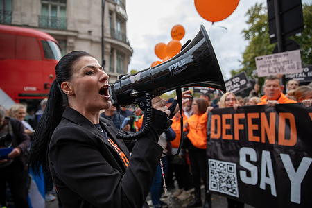 Activist Fiona Rose Diamond, shouts through a megaphone during an anti digital ID demonstration. Hundreds of activists gathered at Marble Arch in Central London to protest against the UK Government's plan to mandate digital identification, known as Brit Cards. Currently, UK citizens are not required by law to carry identification, but the proposed legislation would require all citizens to hold a digital ID.