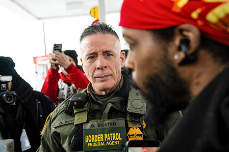 Customs and Border Patrol Chief Greg Bovino speaks with the manager of a Minneapolis gas station. Customs and Border Patrol Chief Greg Bovino and federal immigration agents conducted an enforcement operation in Minneapolis, Minnesota.