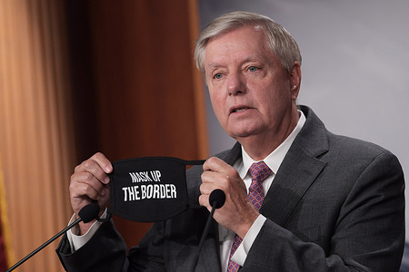 US Senator, Lindsey Graham (R-SC) shows a mask saying 'Mask Up The Border' during a press conference about The US-Mexico Border at Senate Estudio / Capitol Hill.