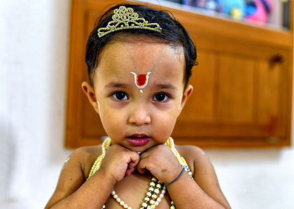 A little kid dressed up as Lord Krishna during the Janmashtami Festival as per traditional ritual.
Due to Covid 19 Temples are restricted for Public access this year and devotees are celebrating the Ritual at home. Krishna Janmashtami is an annual Hindu festival that celebrates the birth of Krishna, the eighth avatar of Vishnu.