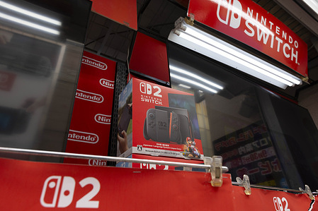 In this photo illustration, the Nintendo Switch 2 advertisement seen displayed at an electronics store. The Nintendo Switch 2 is set to launch on June 5 with a starting price of $449.99 for the base console and $499.99 for a bundle including Mario Kart World. Pre-orders began on April 24 2025 in the U.S. through retailers like GameStop, Best Buy, Walmart and Target but stock sold out quickly due to high demand. Nintendo’s My Nintendo Store uses a registration-based invite system with the first wave of invites sent out starting May 8, 2025 prioritizing Nintendo Switch Online members with at least 12 months of paid membership and 50+ gameplay hours.