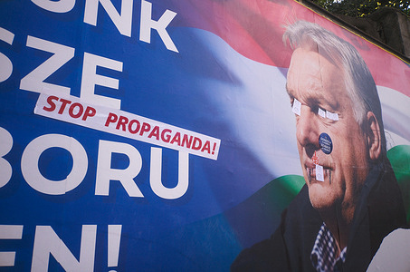 On the way to the rally, a poster of Victor Orban his defaced. On the eve of the Hungarian general election, the political party Fidesz headed by Victor Orban holds a rally at Budapest’s Fisherman’s Bastion square. Attendees carry flags, placards and torches as Orban speaks. Fidesz who have been in power for 16 years are trailing in the polls to TISZA, a party led by ex-Fidesz politician, Peter Magyar.
