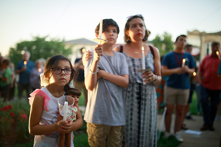 Protesters gather for the Lights for Liberty: A Vigil to End Human Detention Camps rally and candlelight vigil on the steps of the Monroe County Courthouse in Bloomington. United States President Donald J. Trump says ICE will conduct raids against undocumented immigrants in American cities over the weekend.