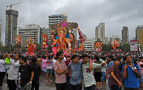 Idols of elephant-headed Hindu god Ganesha arrive on the beach for immersion on Anant Chaturdashi (last day of the festival). Anant Chaturdashi marks the end of a ten day festival of Ganesh Chaturthi (celebrated as birthday of Ganapati) where devotees immerse the idol of elephant-headed Hindu god Ganesha in a free flowing water body amidst chanting of 'come back early next year'.