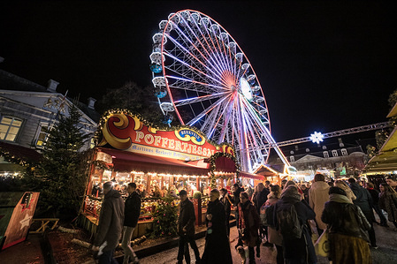 A carousel seen at the Magical Maastricht 2018 Christmas Market in Maastricht city in the Netherlands is a Christmas Market with lot of events, little shops, Glühwein or glow warm wine, lights in trees, carousel, ice rink, Santa's house, slide and a Ferris in a festive environment which attract lots of visitors from the Netherlands, Germany and further away. It takes place from 1 December to 31 December 2018.