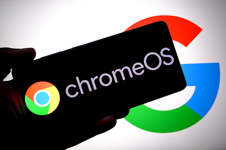 In this photo illustration, a Chrome OS logo is seen displayed on a smartphone with a Google logo in the background.