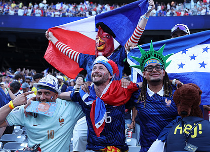 Fans from France and Sweden, wearing colorful costumes and makeup, display a range of emotions at MetLife Stadium, underscoring football’s emotional pull on millions worldwide. France 3 - 0 Sweden
