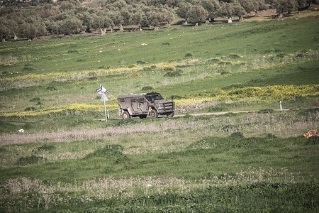 An Israeli military vehicle patrols streets near an Israeli military checkpoint in the northern West Bank, close to the city of Nablus. Israeli forces closed all checkpoints at the entrances to areas under the control of the Palestinian Authority, headed by President Mahmoud Abbas, and arrested dozens of young Palestinians at the checkpoints after Israeli and US airstrikes on the Islamic Republic of Iran.