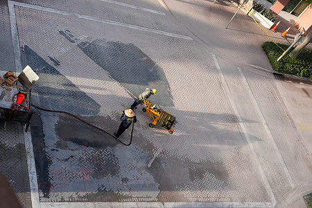 Florida Department of Transportation (FDOT) workers sand blast the site of a rainbow crosswalk in Delray Beach. The Florida Department of Transportation, under Governor Ron DeSantis, announced in June that pride crosswalks must be removed under new policies on road markings.