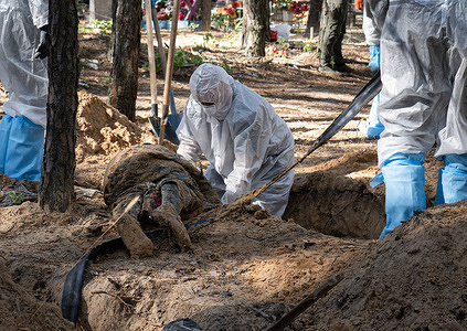 (EDITORS NOTE: Image depicts death)
An investigator wearing protective gear is seen examining an exhumed body. A mass burial site was found on the outskirt of the eastern Ukrainian city, Izium, Kharkiv region, which was liberated from Russian occupation two weeks ago. At least 445 new graves were found on the site of an existing cemetery, while many only have numbers written on the wooden cross. All bodies will be exhumed and sent for forensic examination, but it was told from initial investigations that some bodies showed signs of torture.