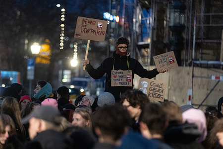 A protester holds placards expressing his opinion during the demonstration. A group of student protesters gather at Wilhelm-Leuschner-Platz as part of a nationwide school strike opposing the conscription reform approved by the Bundestag.