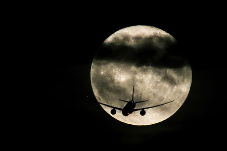 Turkish Airlines Boeing 787-9 civil jet airliner silhouettes against the Supermoon, also known as "Buck Moon" or "Thunder Moon", as approaching Newark Liberty International Airport in Newark, New Jersey.