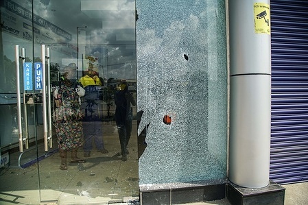 A glass door to an automobile shop is seen shattered by rocks thrown by protesters during a countrywide protest against the government and high cost of living called by Kenya’s opposition leader Raila Odinga.