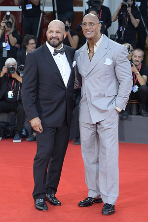 Mark Kerr (L) and Dwayne Johnson (R) attend the red carpet of the film The smashing machine at 82 Venice Film Festival at Palazzo del cinema.
