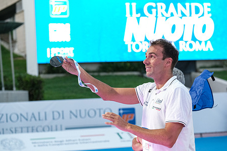 Gregorio Paltrinieri of Italy gives his medal to fans during the podium ceremony for the Men's 1500m Freestyle on the third day of the 61st Settecolli Trophy international swimming competition.