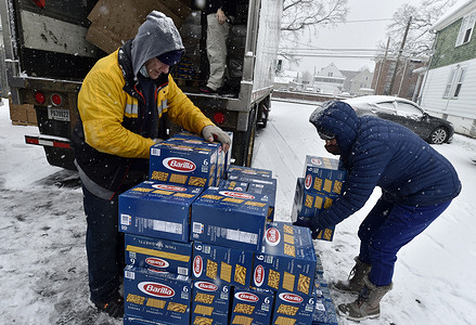 Workers prepare for the weekly drive thru food pick up at the Al Beech West Side Food Pantry.
The need for food banks is at its max due to unemployment and a rise in Covid-19 cases.