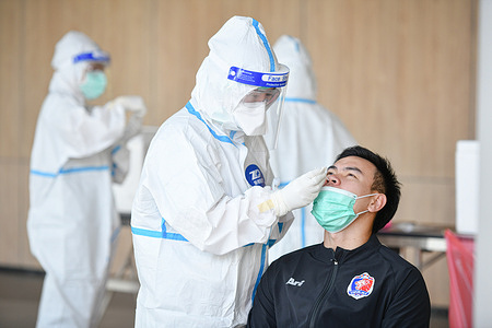 A health worker wearing a protective suit collects a nasal swab sample from Worawut Srisupha, a football player of Port FC to test for COVID-19 coronavirus at Modena hotel in Buriram.
The Ministry of Public Health of Thailand has recorded 270,921 coronavirus cases, 214,340 recovered and 2,133 deaths.