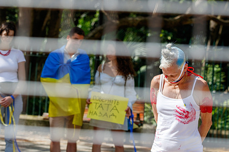 Demonstrators take part in a silent protest outside Queensland Parliament in Brisbane. Demonstrators gathered outside Queensland Parliament in Brisbane to protest against rape committed by Russian soldiers against Ukrainian civilians. Speakers suggested the regularity and viciousness of the crimes indicated they were not isolated incidents, but violence sanctioned by Russian leadership and military to demoralize the Ukrainian civilian populace.