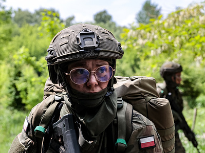 Candidates for Territorial Defence soldiers seen marching in a defensive formation take exams after finishing 16 days ''Tactical Loop'' training in Pasternik Garrison Training Center (GOSz). Successful candidates after taking the oath will join the 11th Lesser Poland Territorial Defense Brigade. Territorial Defence army is an organization that trains civilians who voluntarily wish to acquire military and defence skills. Volunteers from various parts of Lesser Poland who have not had any contact with military service before acquire the basics of military craft. They learned among other skills, the construction and operation of military equipment, the basics of shooting, tactics, topography, rules of conduct on the battlefield and survival and providing first aid on the battlefield.