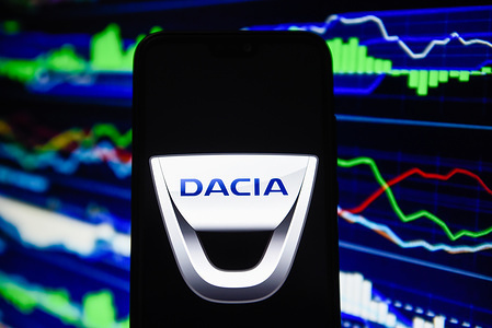 In this photo illustration a Dacia logo is seen on an android mobile phone.
