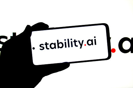 In this photo illustration, a stabilty AI logo seen displayed on a smartphone and in the background.