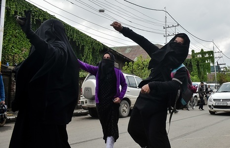 A Kashmiri female student protester throw stones towards government forces during clashes in Srinagar, Indian administered Kashmir. Four civilians were killed when government forces fired on Kashmiri protesters near the site of encounter in Kulgam district of Indian administered Kashmir. As soon as the news of the killings spread, the students of various institutions hit the streets and staged protest. The protesters raised pro-freedom and anti-India slogans. Meanwhile the separatists have called for a shutdown on Thursday & Friday against the killings.