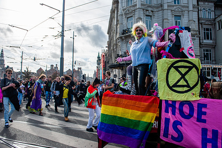 Activists from the climate group Extinction Rebellion are seen dancing on the streets during the demonstration. ADEV (Amsterdam Danst Ergens Voor) which means something like 'Amsterdam Dances For Something' organized for the tenth time its annual demonstration for squatting, free spaces, and affordable housing in the city. Thousands of people danced accompanied by large trucks with loud music systems through the center of Amsterdam. Protesters danced to express their dissatisfaction with what they see as unaffordable housing and argue for more free spaces in the city, and also to be able to squat.