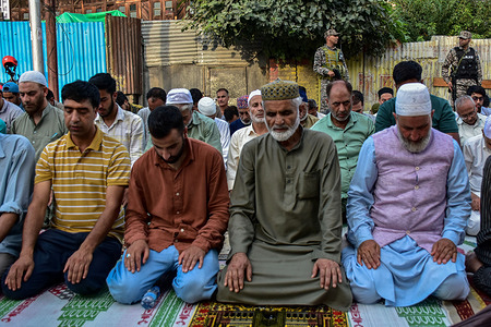 Paramilitary troopers keep vigil as Kashmiri Muslims offer traditional congregational prayers at the shrine of Naqshband Sahib during an annual festival locally known as "Khawaja-e-Digar". Thousands of devotees converged at the shrine of Khwaja Naqshband Sahib to participate in the annual congregational prayers called Khawaja-e-Digar' on the 3rd of Rabi-ul-Awal, the third month of the Islamic calendar.