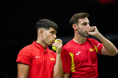 Carlos Alcaraz (L) and Marcel Granollers (R) of Spain team prepare to play against Jakub Mensik and Adam Pavlasek of Czechia team during the Davis Cup Final Group B doubles match at Pabellon Fuente de San Luis. Spain won 7/6, 3/6, 6/7