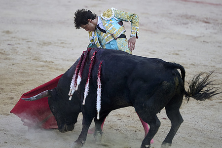 Andres Roca Rey seen bullfighting a bull from the Jandilla ranch. The bullfight was taking place in the context of the annual San Fermin Festival, which also features bull runs through the streets of Pamplona. The festival began in medieval times.