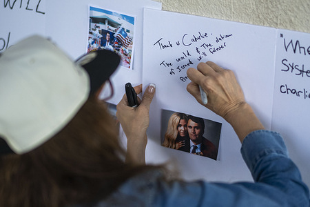 A woman visits a memorial for Charlie Kirk in Beverly Hills on Sept. 14, 2025. Kirk, CEO and co-founder of Turning Point USA, was shot and killed Wednesday in Utah.