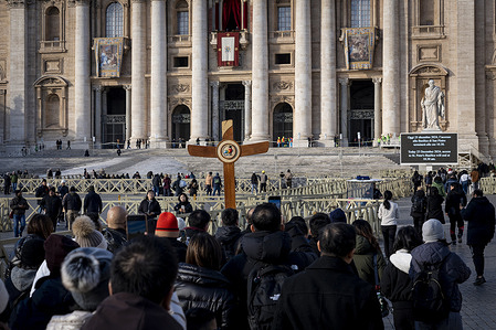 Pilgrims arrive to walk through the Holy Door. 
Faithful walk through the Holy Door of St. Peter's Basilica at the Vatican after it was opened by Pope Francis on Christmas Eve marking the start of the Catholic 2025 Jubilee.