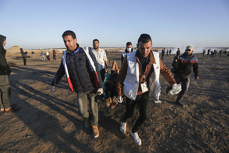 A wounded Palestinian being evacuated during the demonstration.
Palestinians clash with Israeli security forces while demanding for an end to the Israeli blockade of Gaza and the right of return to their homeland at the border fence between Israel and Gaza in southern Gaza Strip.