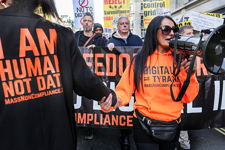 Protesters lead the chanting through megaphones during the rally, being lead by David Icke and his son Gareth. The Mass Non Compliance group are protesting against the Labour Government's plan to introduce digital identity cards, claiming that it would increase the government's surveillance powers while threatening individual privacy and freedom.