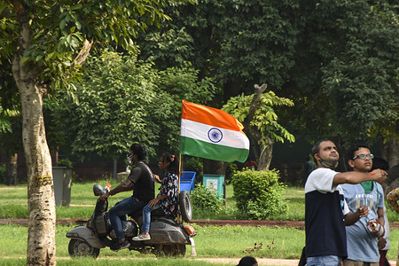 A man and a girl riding on scooter with an Indian flag during the occasion.
India celebrated its 74th Independence Day. It is annually celebrated on 15th August as a national holiday commemorating the nation's independence from the United Kingdom on 15 August 1947.