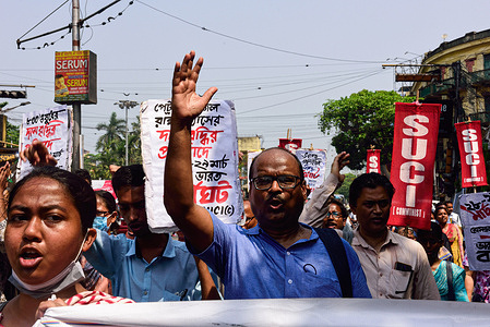 Leftist party workers chant a rallying cry during the first day of the two-day nationwide strike against the policies of the central government of India.