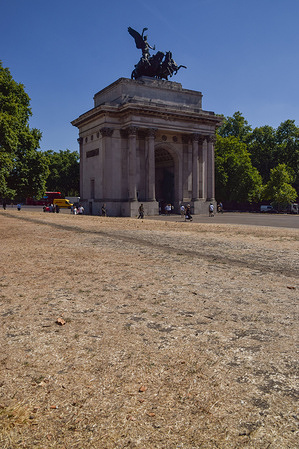 Parched and scorched grass is seen in Wellington arch Hyde park corner as heatwaves and drought caused by climate change continue in the UK.